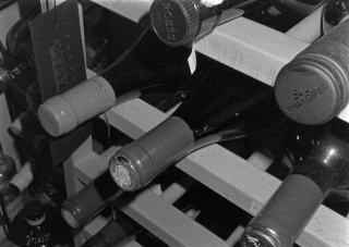 Bordeaux wine bottles resting in a cellar rack